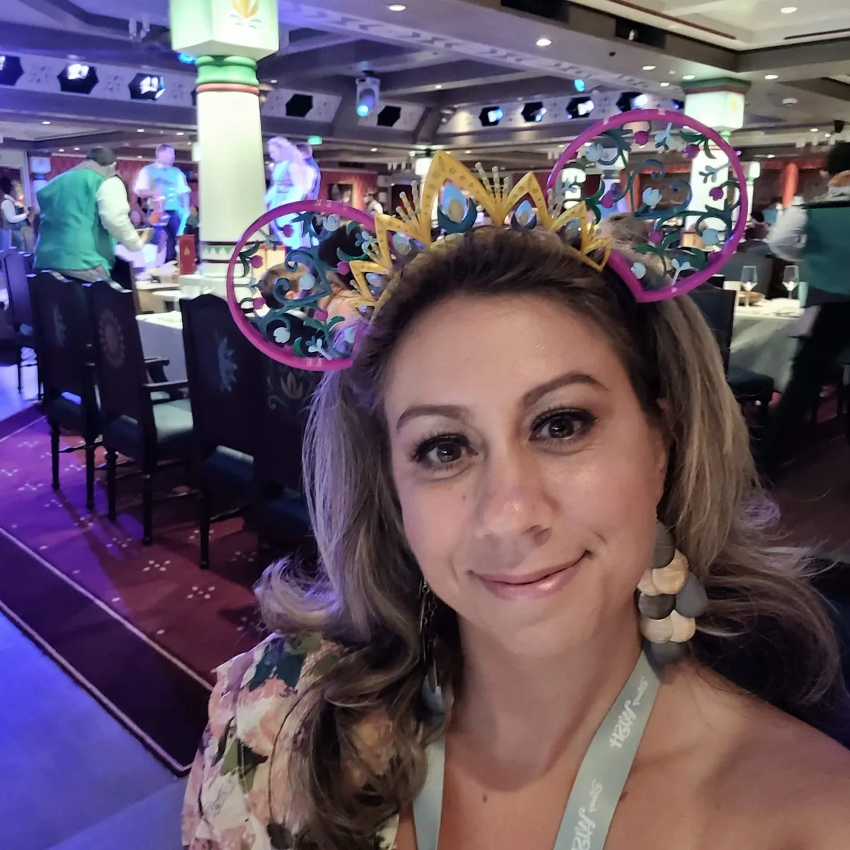 Fallon Bilis wearing Elsa ears in a Disney Cruise Line dining room.