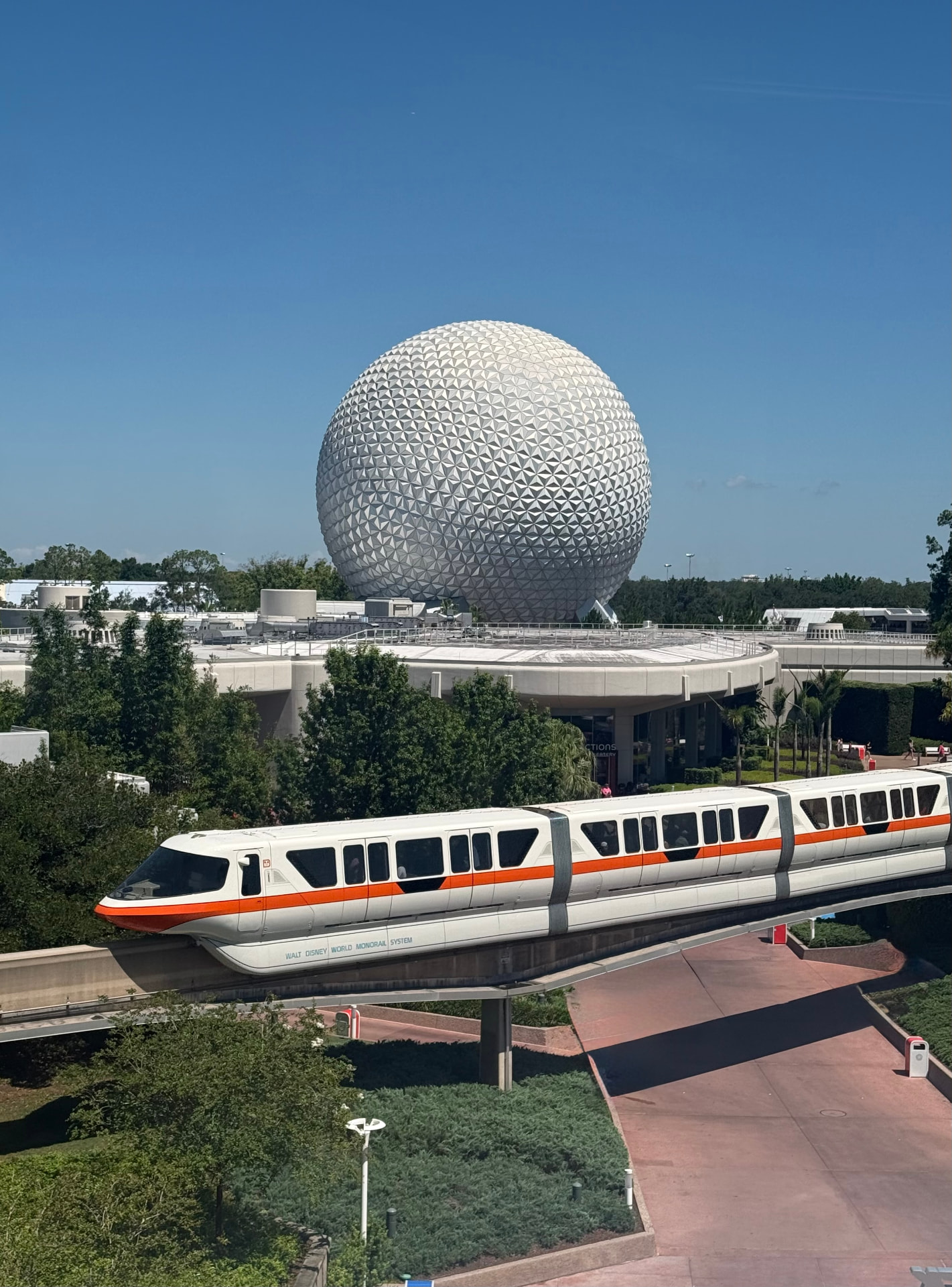The Walt Disney World Monorail passing Spaceship Earth at Epcot on a clear day