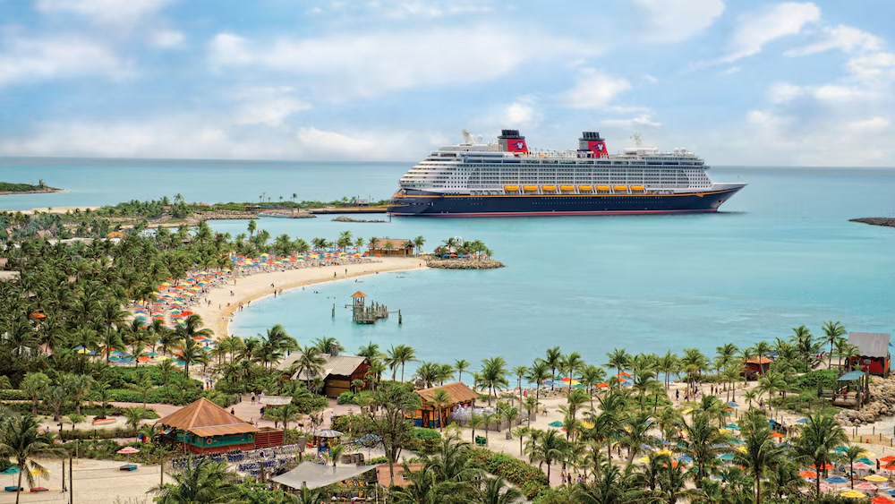 A Disney cruise ship docked at Castaway Cay, seen over the island's beaches