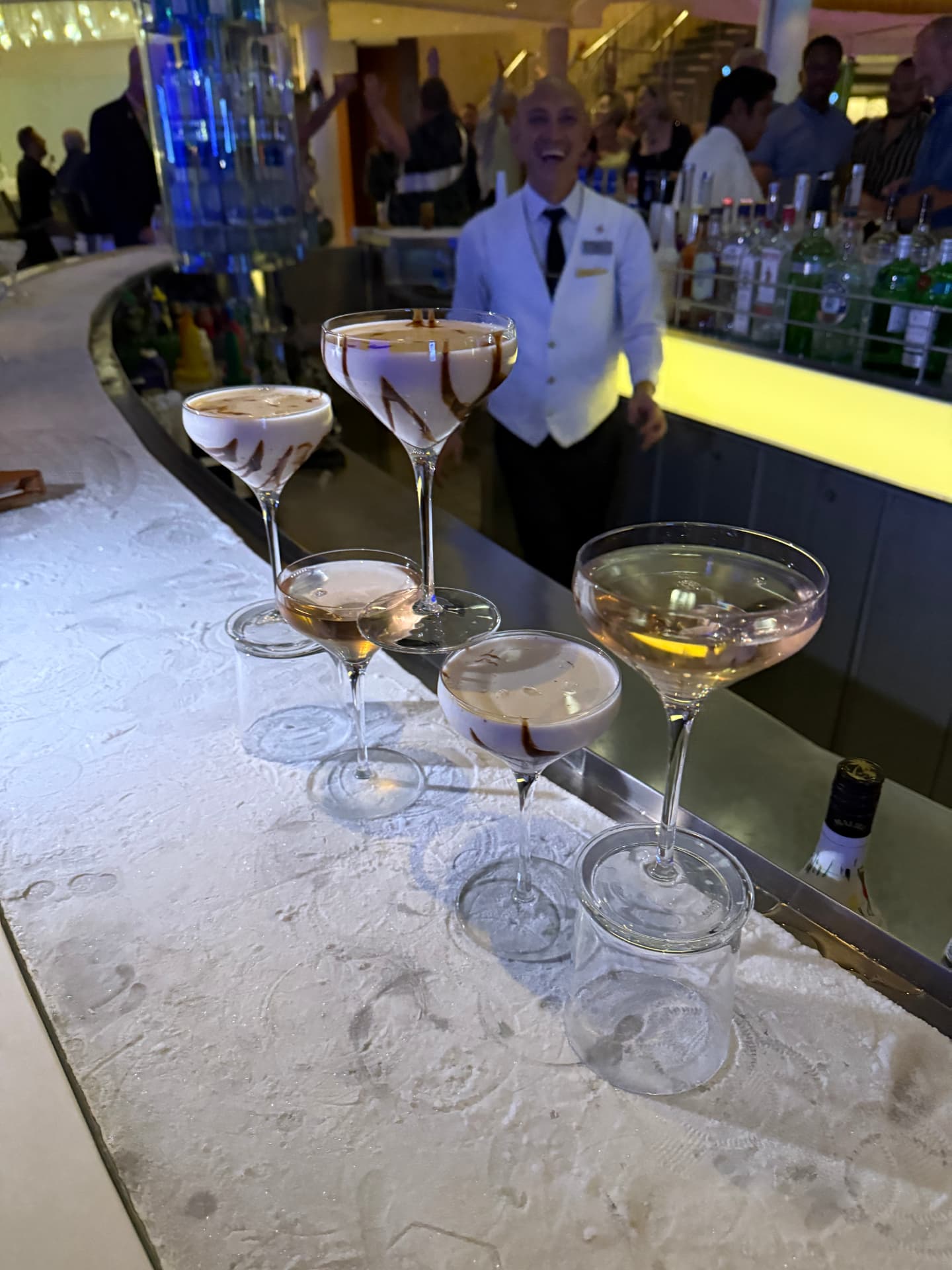Chocolate-topped cocktails lined up on a bar counter