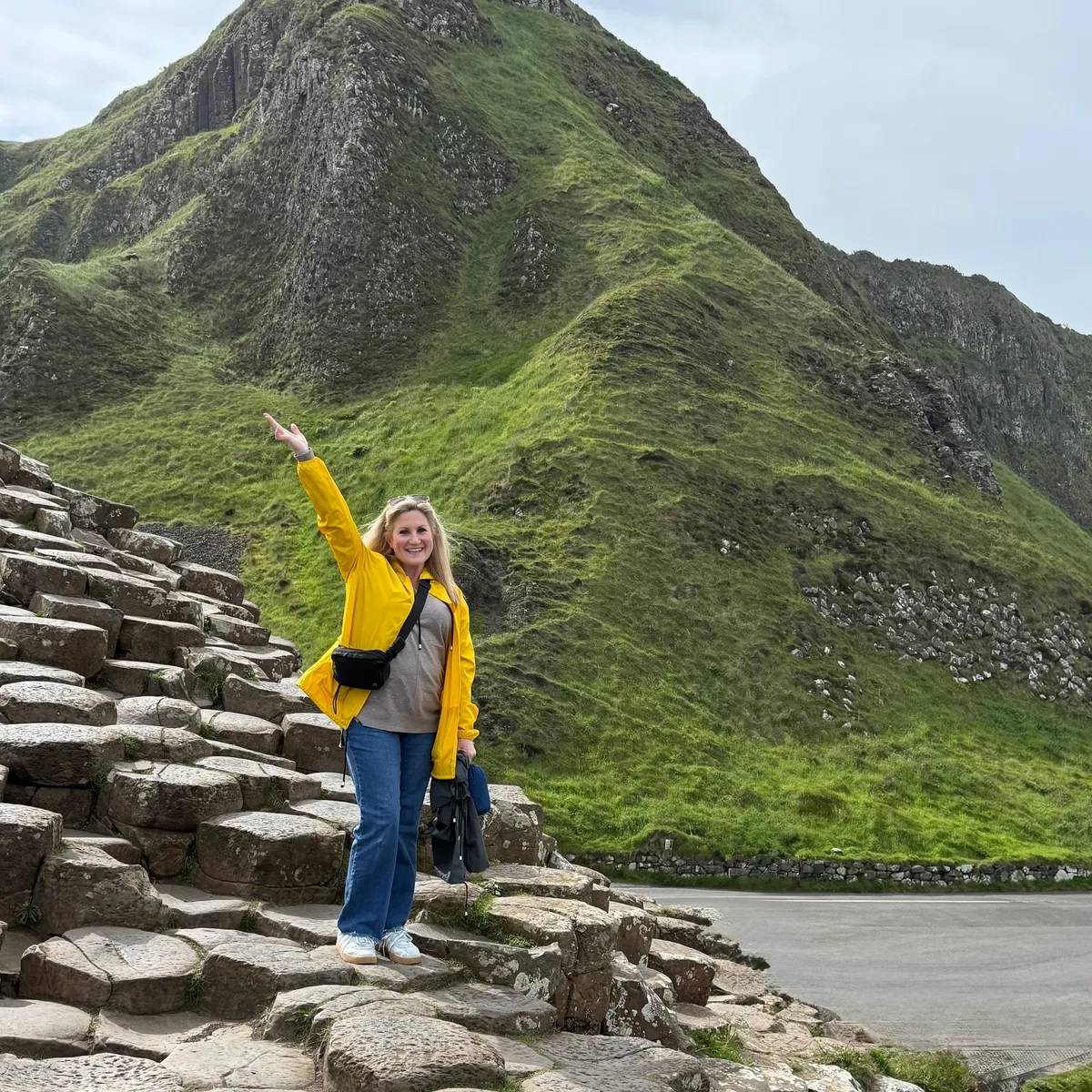Bridget Edwards in a yellow jacket at Giant's Causeway in Ireland.