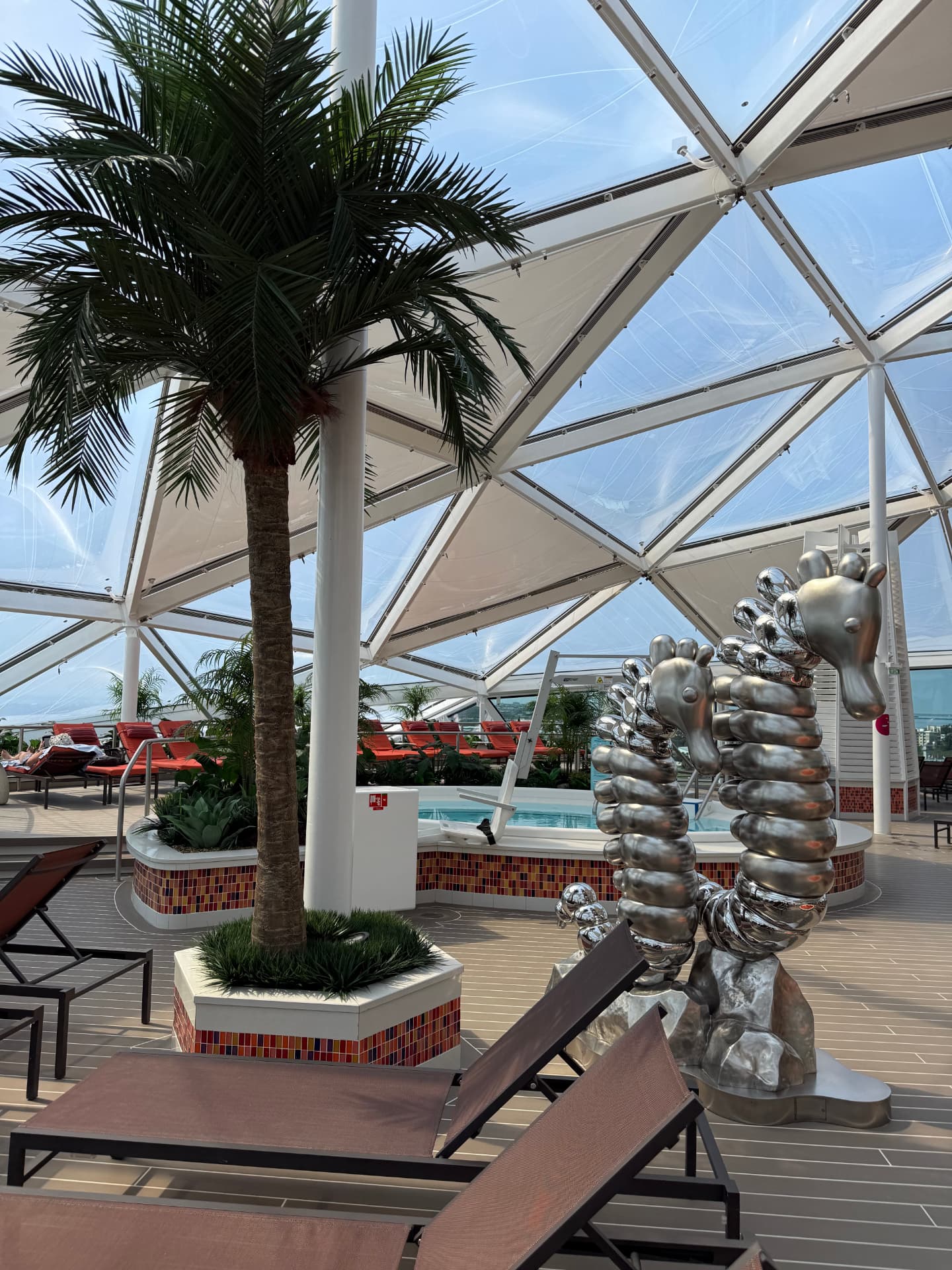 Silver seahorse sculptures under the glass roof of the Solarium