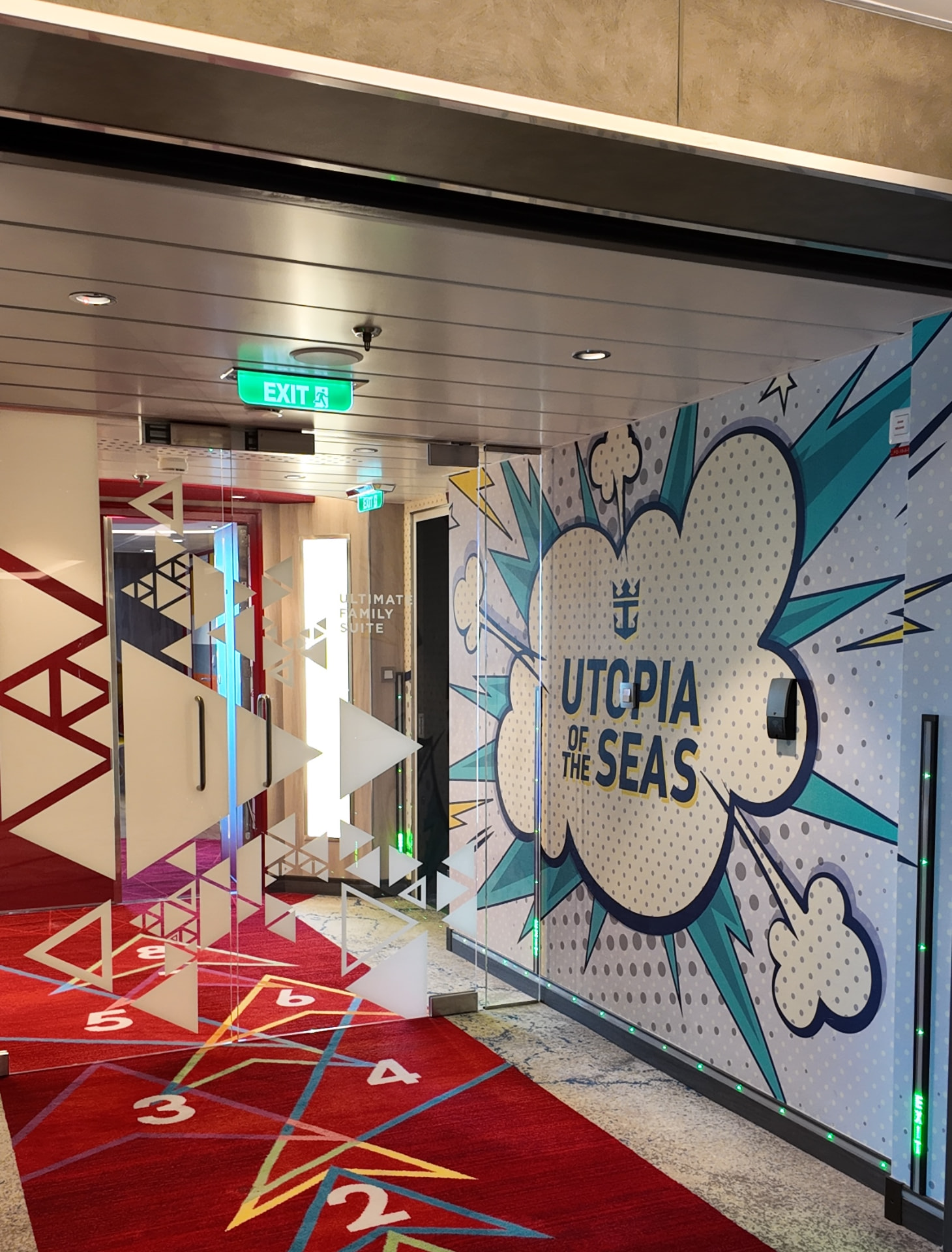 A comic book style mural reading Utopia of the Seas in a ship corridor