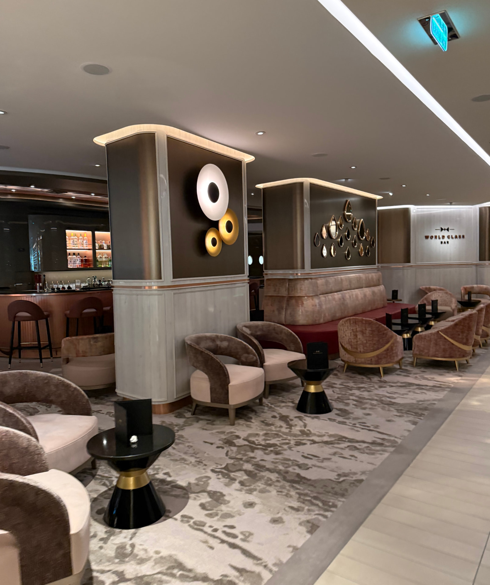 A plush bar lounge with curved velvet chairs and warm gold lighting