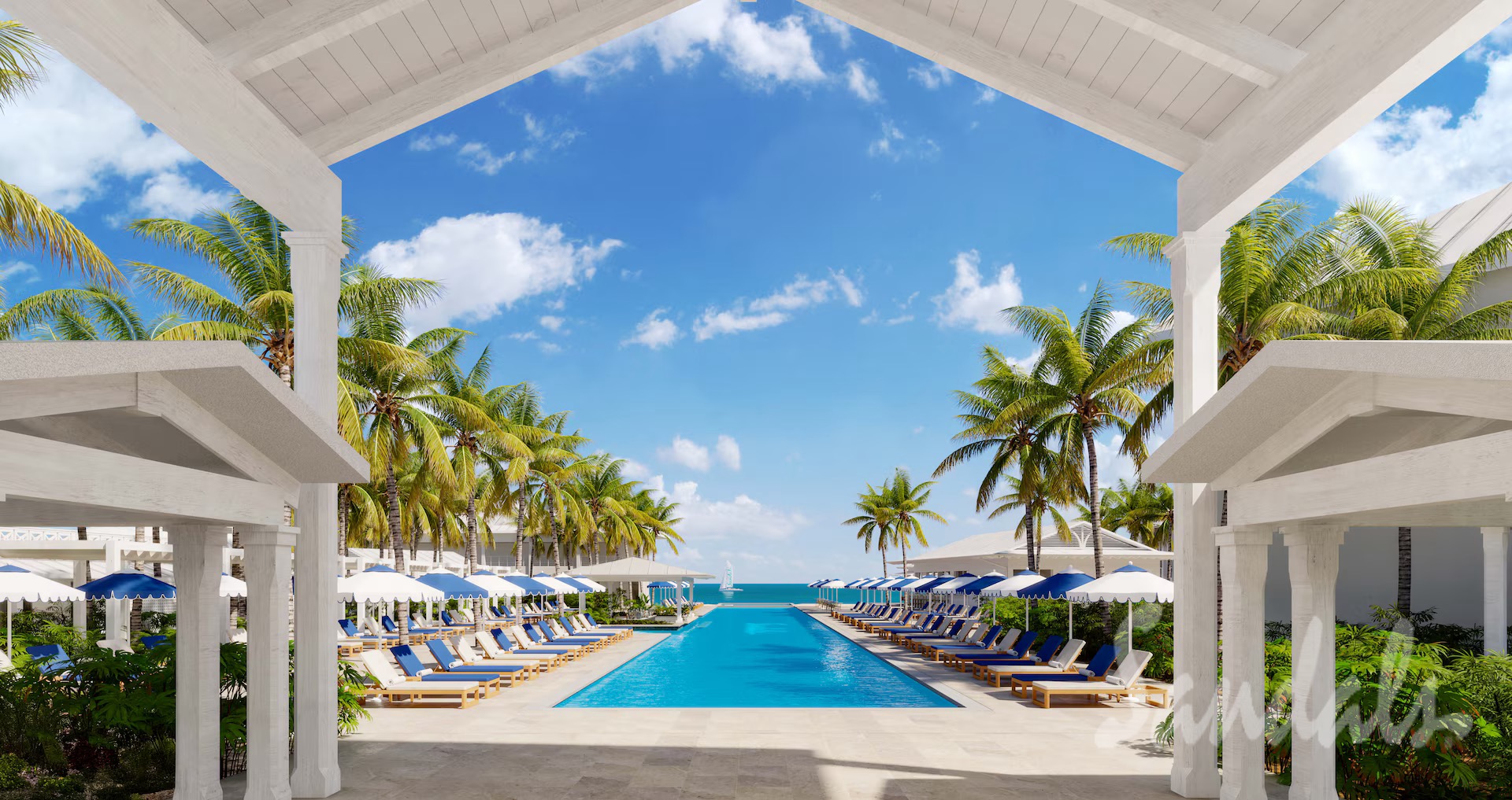 Aerial view of the pool, palm trees, and white buildings at Sandals Jamaica Caribbean Cay