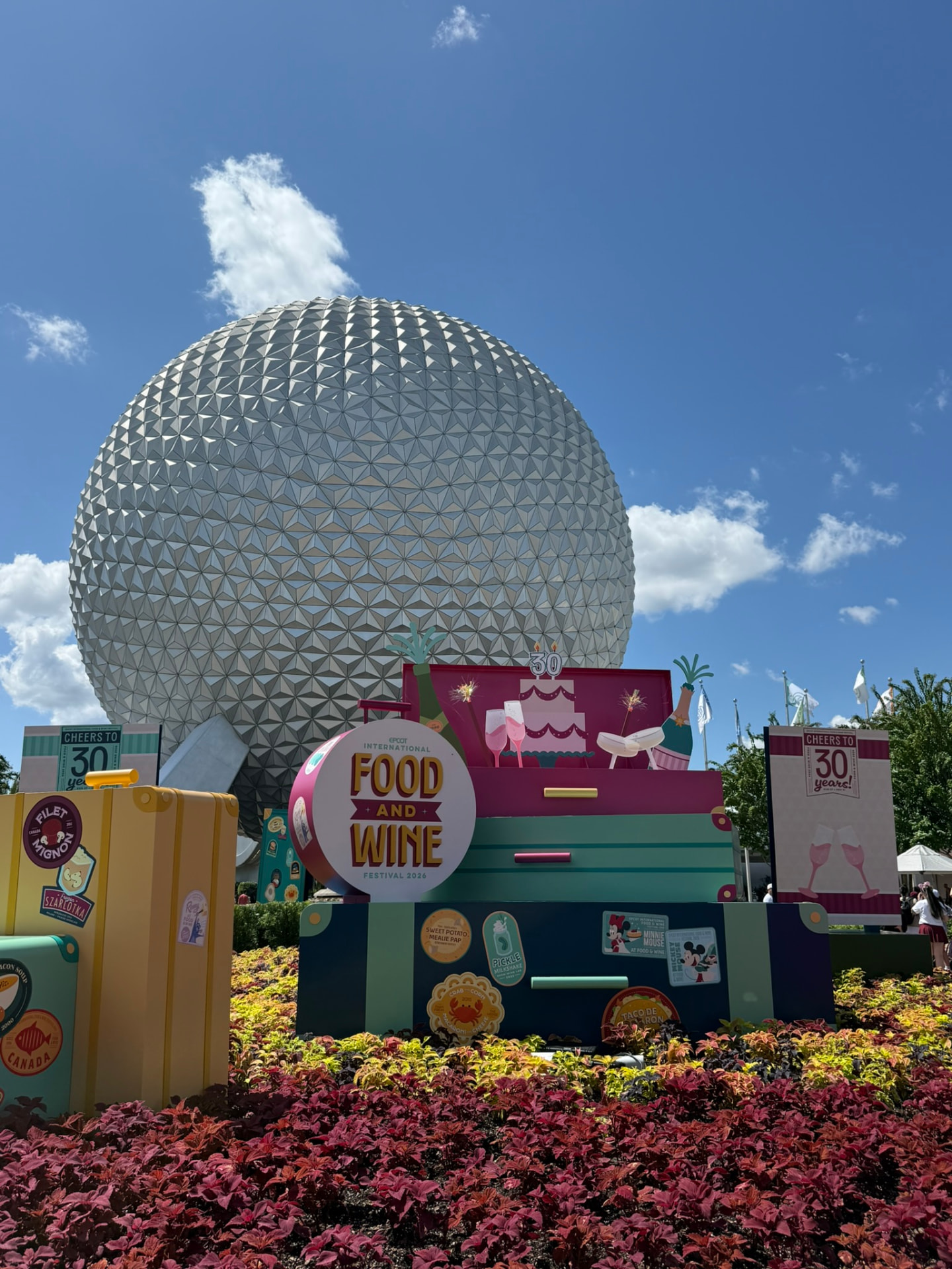Spaceship Earth over the Food and Wine Festival topiaries at Epcot
